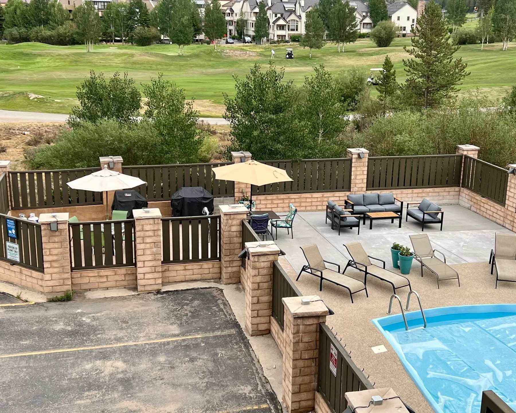 Pool deck lounge, seating, barbecue grills and golf course view